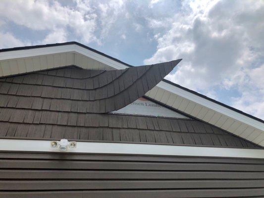 Architectural "shake siding" blew loose in relatively mild 20-25 mph winds on June 17, 2021.