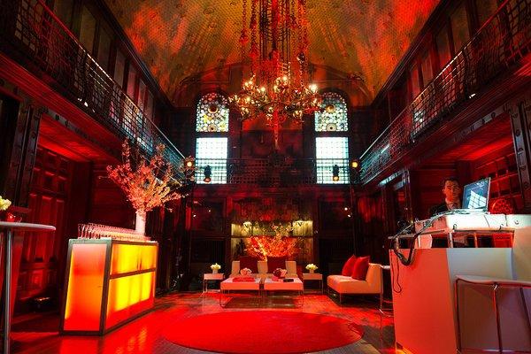 Deep red gobo texture, uplights, and bar illumination at The Park Avenue Armory.