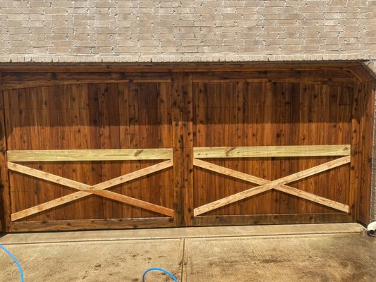 Here we have a garage door we restained and replaced some damaged wood on it.