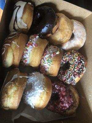 Assorted donuts in their box. Kids eating.