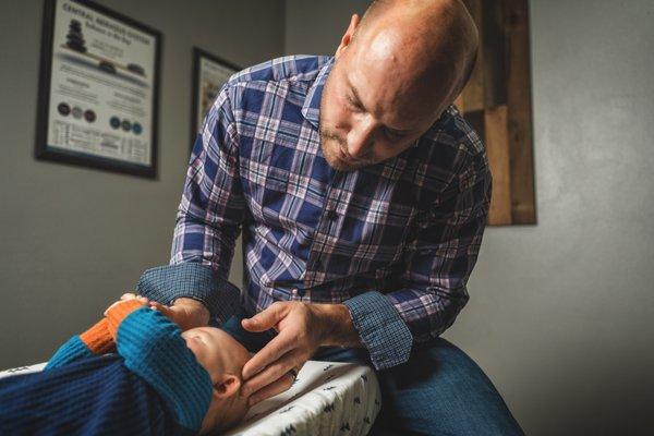 Performing infant cranial bone assessment to help in properly improving nervous system function