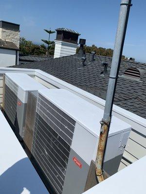 Rooftop air-conditioners. The tops painted to match the rooftop where they will be seen