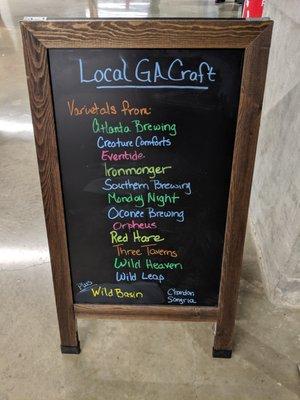 Blackboard stand showing local beer varietals offered.