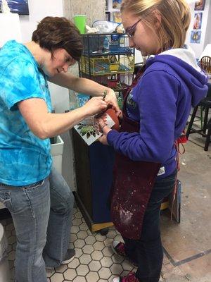 Jennifer helping my daughter with stenciling her mug.