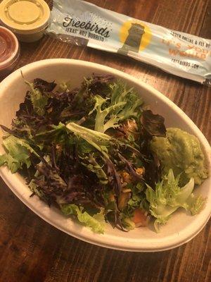 Seasoned Chicken bowl with mixed greens, cilantro lime rice, black beans, pico, guacamole, roasted garlic