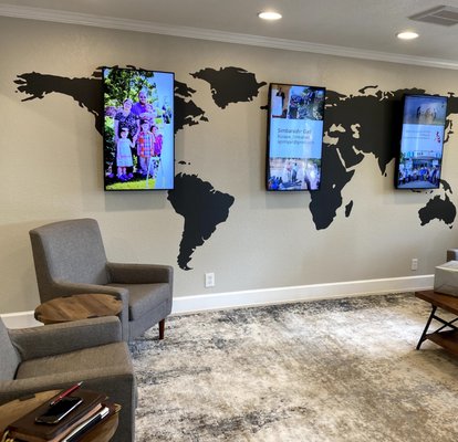 Cedar Park church of Christ's entrance displaying it's work across the globe.