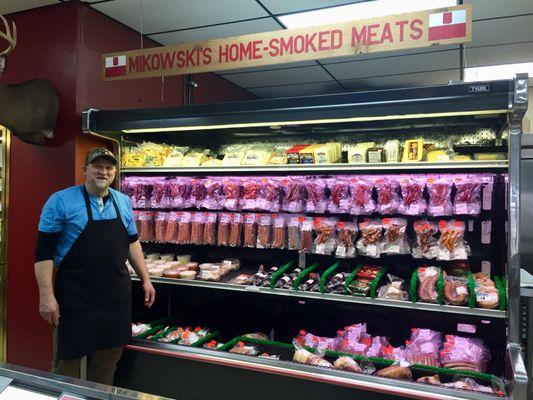 Owner, Roger Mikowski by his fully stocked meat case.