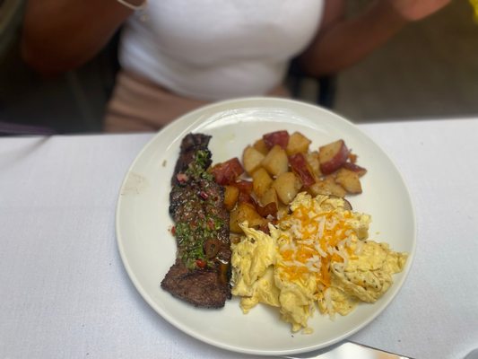 Steak and potatoes with scrambled eggs