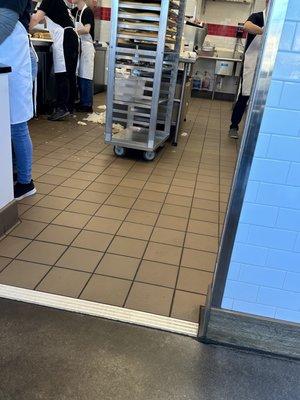 Kitchen staff throws food on the floor as they work. Occasionally someone picks it up.