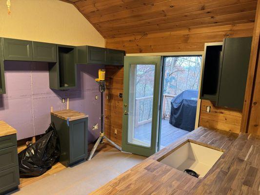 My cabin kitchen with new cabinet being installed