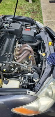 Engine bay. Proves that the cap was left off. If it wasn't it would have fallen through the engine bay.  Yellow cap is where I found it