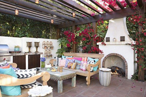 Pergola with outdoor kitchen, fireplace and lounge area. Photo by Karyn Millet.