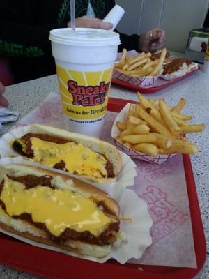 Two chili cheese dogs with fries.