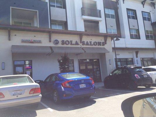 Exterior of the Sola Salons from the parking lot.