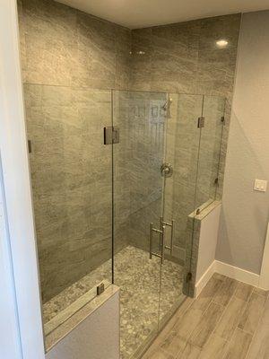 Frameless shower enclosure with a double door