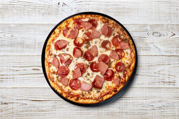 Indulge in a carnivore's delight with our Meat Lovers Pizza. Loaded with pepperoni, sausage, beef, Canadian bacon, and melted mozzarella, it