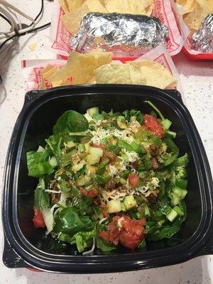 Chicken burrito bowl with lots of fresh veggies.