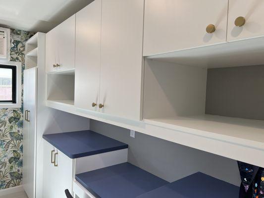 Laundry room. The open shelving was designed for all my cookbooks that don't fit in my house. The little desk area is for crafting.