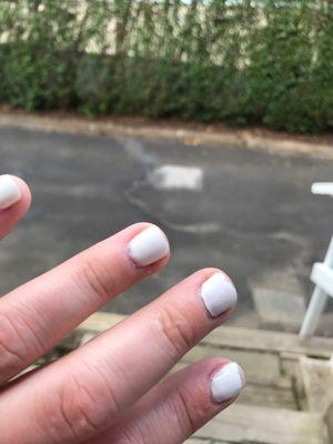 Lifted nail polish, unsecured to the nail, was painted all over cuticle