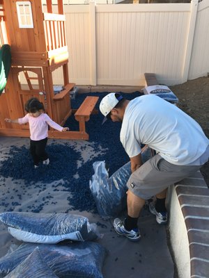 My daughter playing in the mulch while I pour..