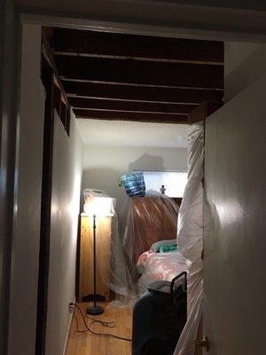 The ceiling & bedroom wall that was ripped out all over my stuff. They used improper tarp materials that did not protect my stuff!