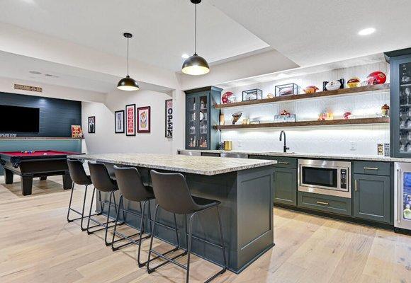 Transitional bar set up with lighted floating shelves, LVP flooring.