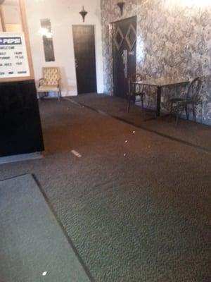 Lobby- covered in sticky pop, crushed popcorn and dirt