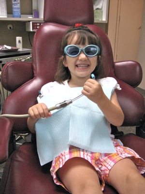 She loves picking out a pair of kids' sunglasses to wear.