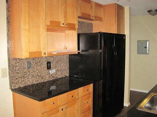 Kitchen renovation with cabinets from Stock Cabinet Express. Counters from Home Depot (Absolute Black granite). Custom marble backsplash.