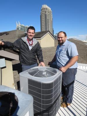 Owner Houston McBroom and technician Erick standing next to the new Carrier heat pump they just installed for me. I couldn't be happier.