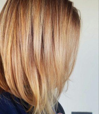 Strawberry blonde blended into honey highlights