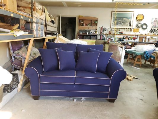 Loveseat made with charlotte micro fiber fabric color sapphire with taupe contrast welt.