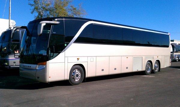 A charter bus sits up to 57 people. Thanks to its amenities and cargo space, it's perfect for both over-the-road an local trips.