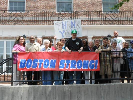 Staff & resident showing support to police, fire, emergency services and victims of marathon bombings.