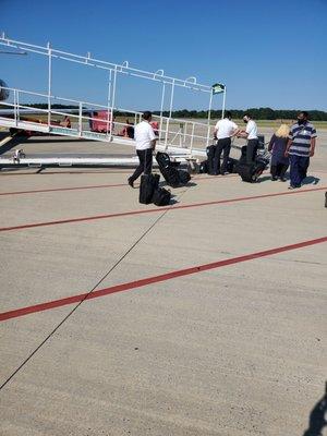 Pilots for the next scheduled flight waiting for arriving pilots to get off the plane.