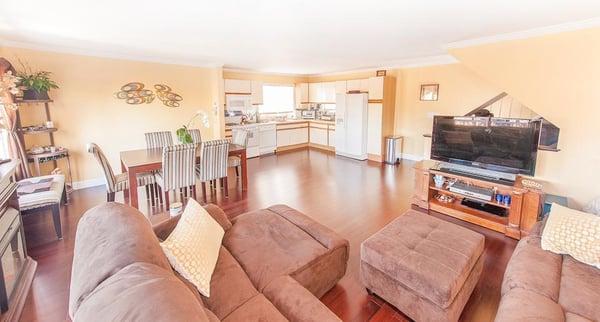 The kitchen wall was removed to create and open concept floor plan. Solid bamboo flooring was installed throughout. 