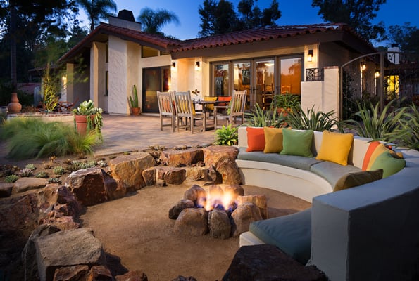 Sunken patio with decomposed granite and boulders creating a fire pit