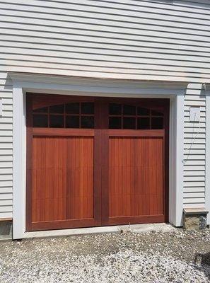 Red cedar wooden garage door manufactured by Overhead Door Company.