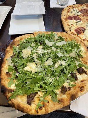 Short Rib Pizza with caramelized, onions, ricotta, shaved, Parmesan, arugula, and truffle oil