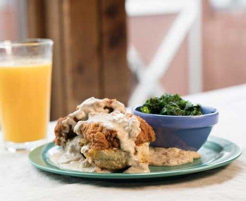 Homegrown West Open faced chicken, gravy, and cheese biscuit with a side of collards.