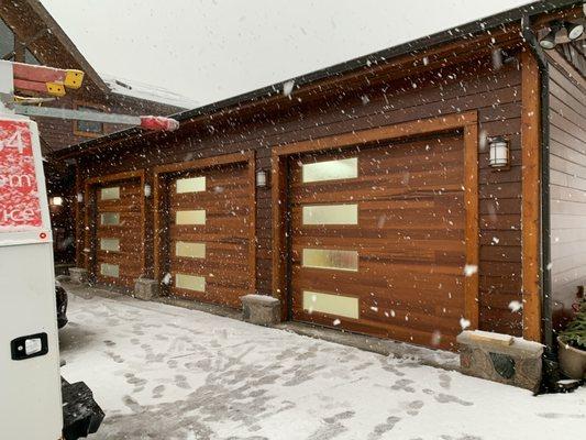 The Planks style wood tone garage doors enhanced the look of this home greatly.