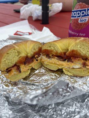 Bacon fried egg and cheese on a toasted egg bagel.