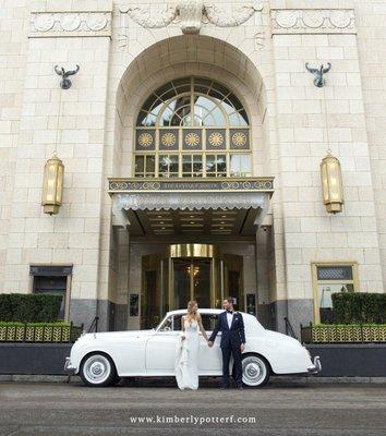 Newlyweds on their wedding day in front of the Hotel Leveque in downtown Columbus