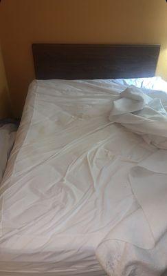 Bed stained in what appears to be urine