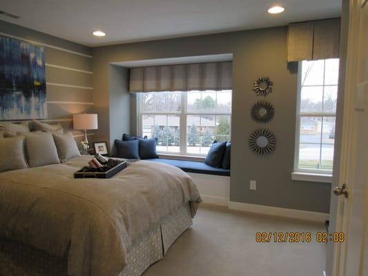 Custom valance, bedding, pillows, and window cushion designed by Joy Fahringer