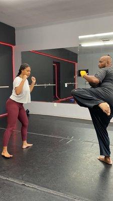 Instructor Correy showing the proper form for a round kick.