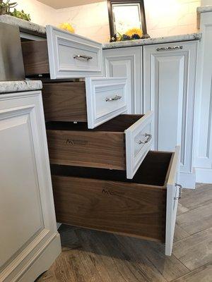 Walnut drawer boxes paired with light grey painted cabinets. A beautiful design.