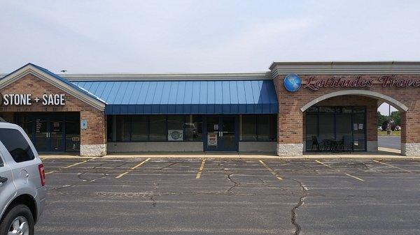 I'm located in Latitude's Travel. Entrance under the blue awning.