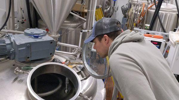 Dave Winslow, head brewer at Jackson Street Brewing, checking on the brewing process.