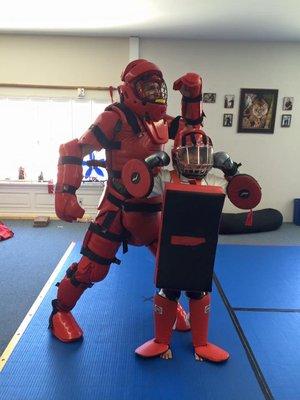 Master Joe and his youngest niece suited up to engage students in a Women's Self Defense Workshop.